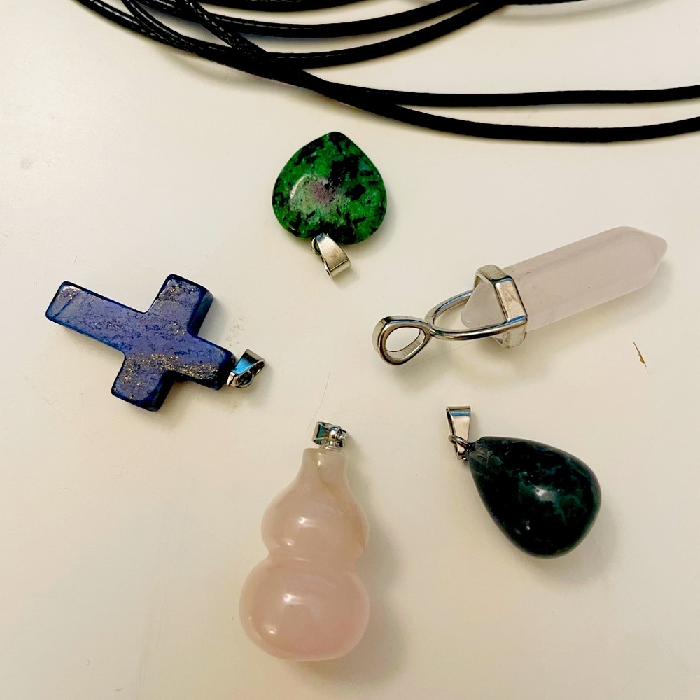 5 crystal pendents with black necklaces for each pendants